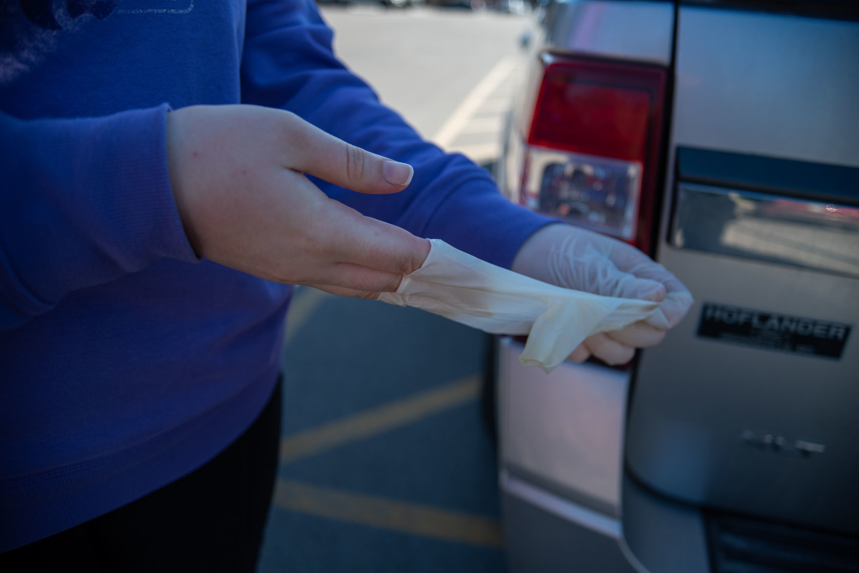 Katie Rehkop takes off her gloves after moving out of Wefald Hall on Friday.